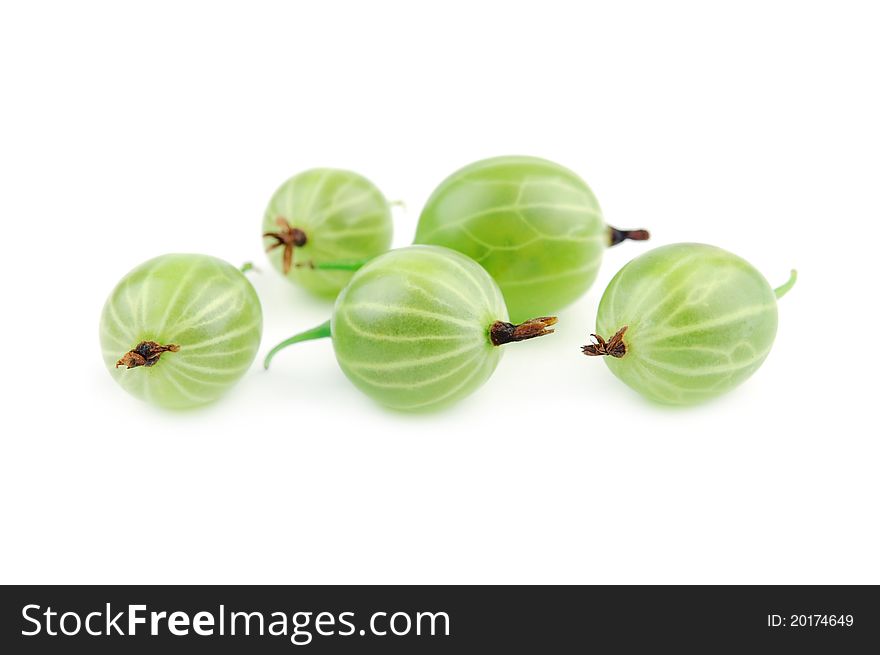 Green gooseberry fruit closeup on a white background. Selective focus. Green gooseberry fruit closeup on a white background. Selective focus.