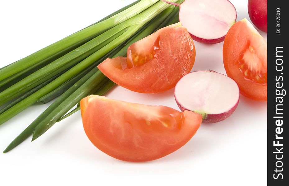 Tomato, garden radish by lobules and spring onions on a white background. Tomato, garden radish by lobules and spring onions on a white background