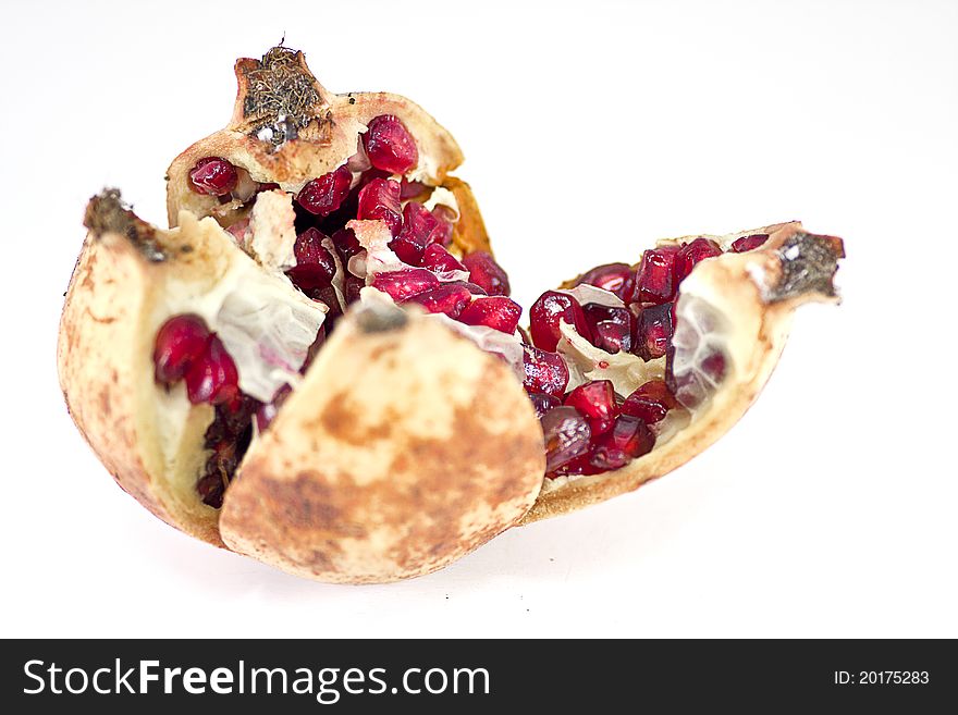 An open pomegranate exposing many rubies like fruits.