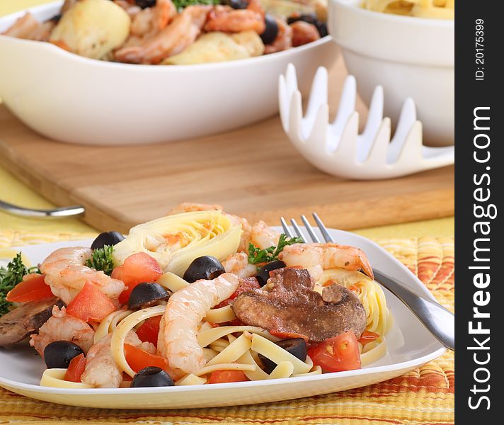 Shrimp with fettuccine noodles and vegetables on a plate. Shrimp with fettuccine noodles and vegetables on a plate