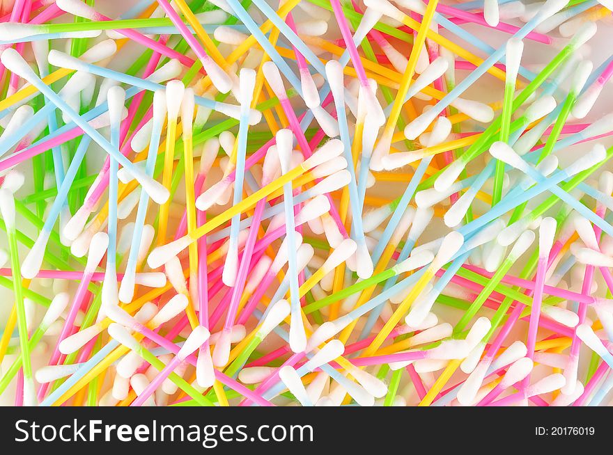 Colorful cotton swabs on light background