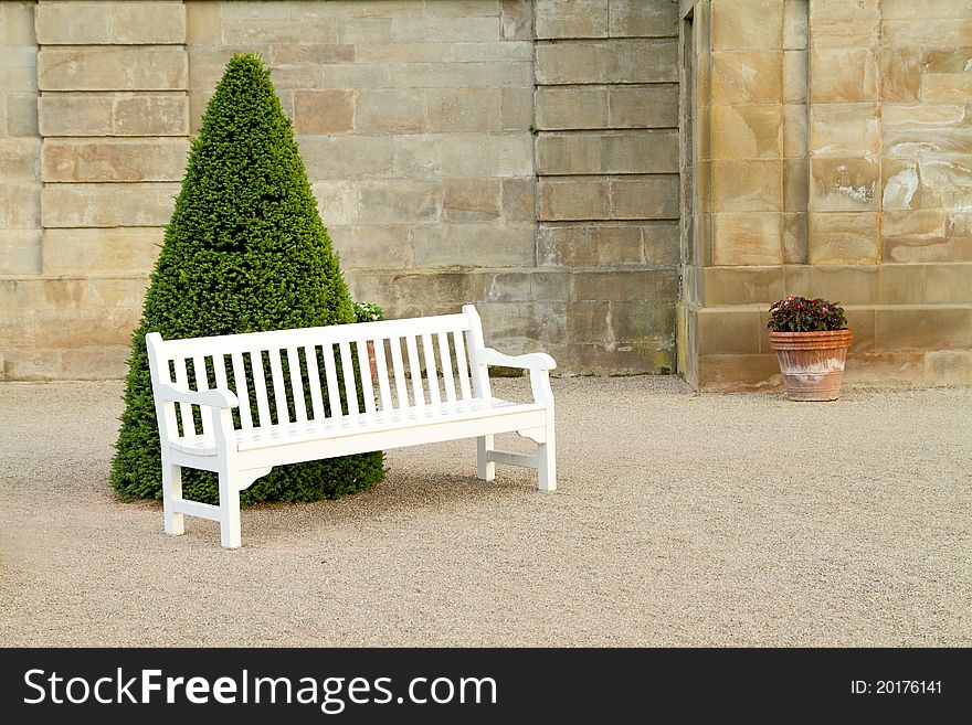 Empty white wooden bench in yard. Empty white wooden bench in yard