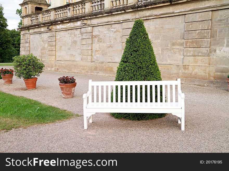 Empty white wooden bench in yard. Empty white wooden bench in yard