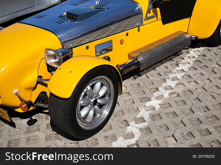 Close view of a weird yellow sports car parked on a park. Close view of a weird yellow sports car parked on a park.