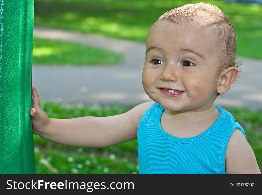 Portrait of a baby smiling in a park. Portrait of a baby smiling in a park
