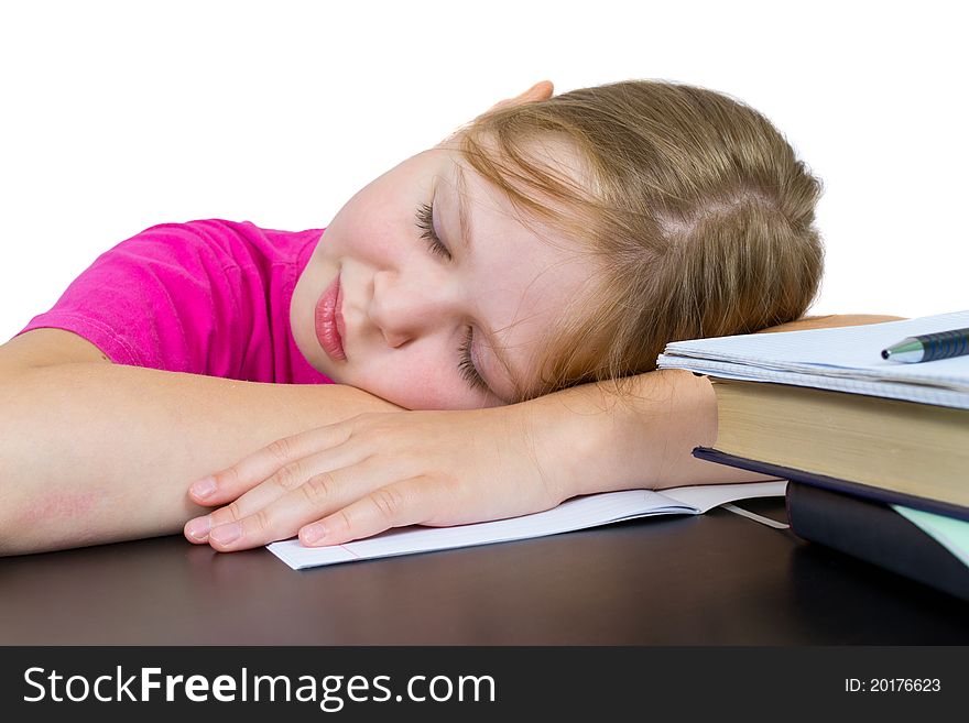 The girl has fallen asleep over textbooks