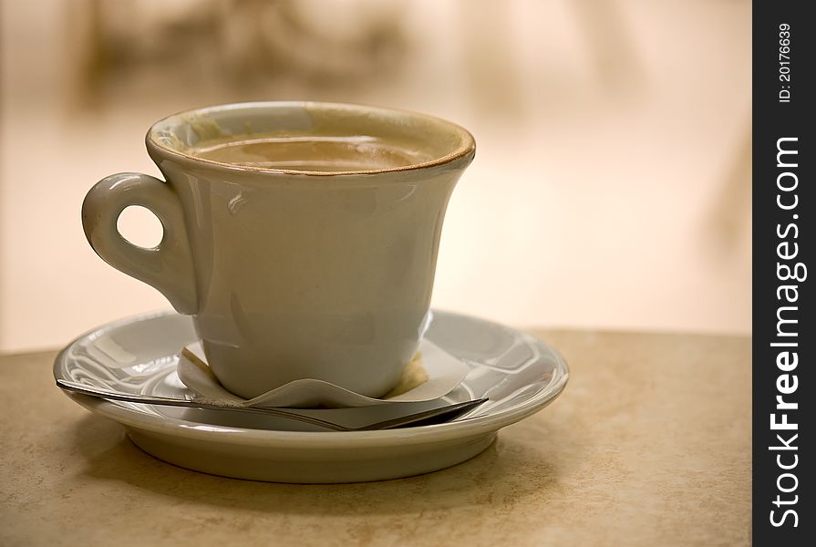 Coffee cappuccino Cup on table in cafe on light background. Coffee cappuccino Cup on table in cafe on light background.