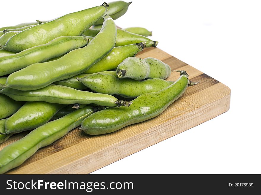 Close up view of some broad beans isolated on a white background.