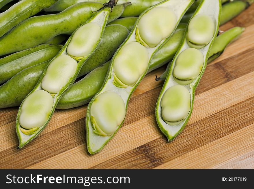 Close up view of some broad beans  on a white background.