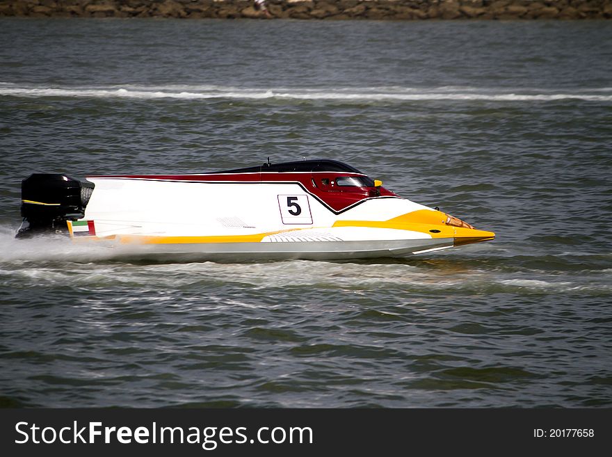 View of a powerboat race on a lake in Portugal. View of a powerboat race on a lake in Portugal.