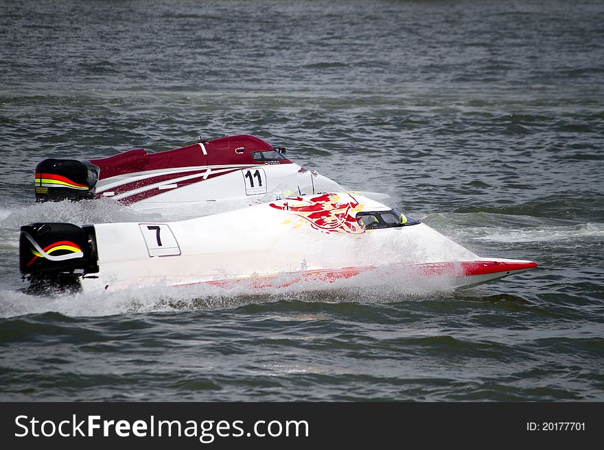 View of two powerboats racing on a lake in Portugal. View of two powerboats racing on a lake in Portugal.
