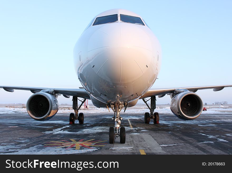 The plane on parking at the airport. The plane on parking at the airport.