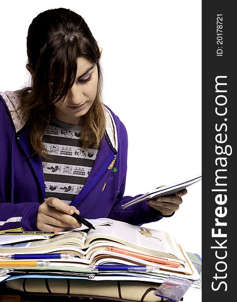 View of a teenager school girl studying on a white background. View of a teenager school girl studying on a white background.