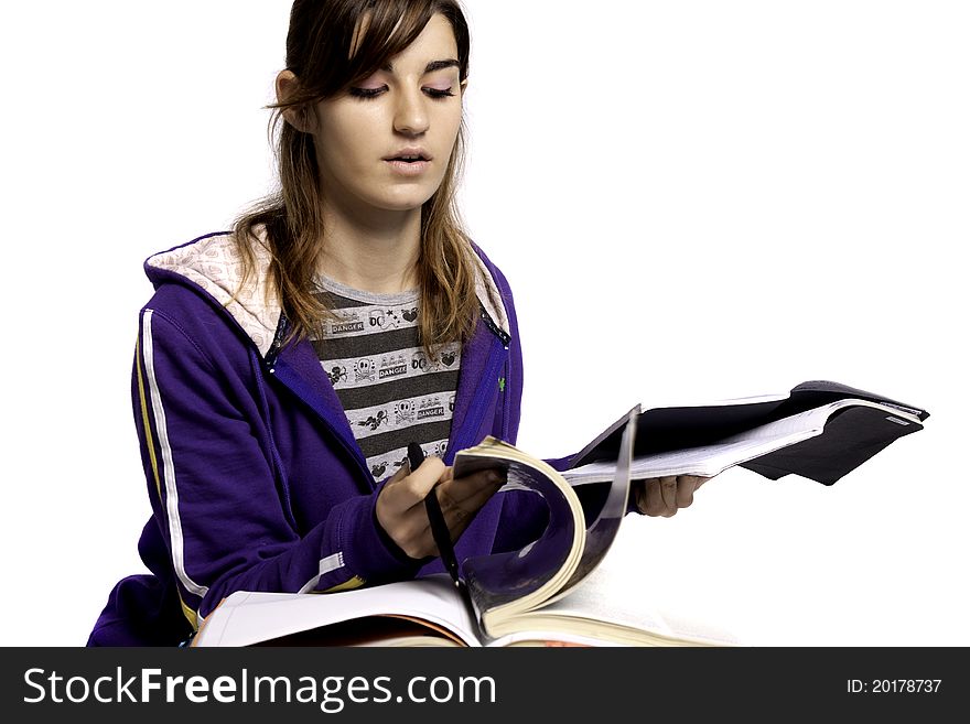 View of a teenager school girl studying on a white background. View of a teenager school girl studying on a white background.