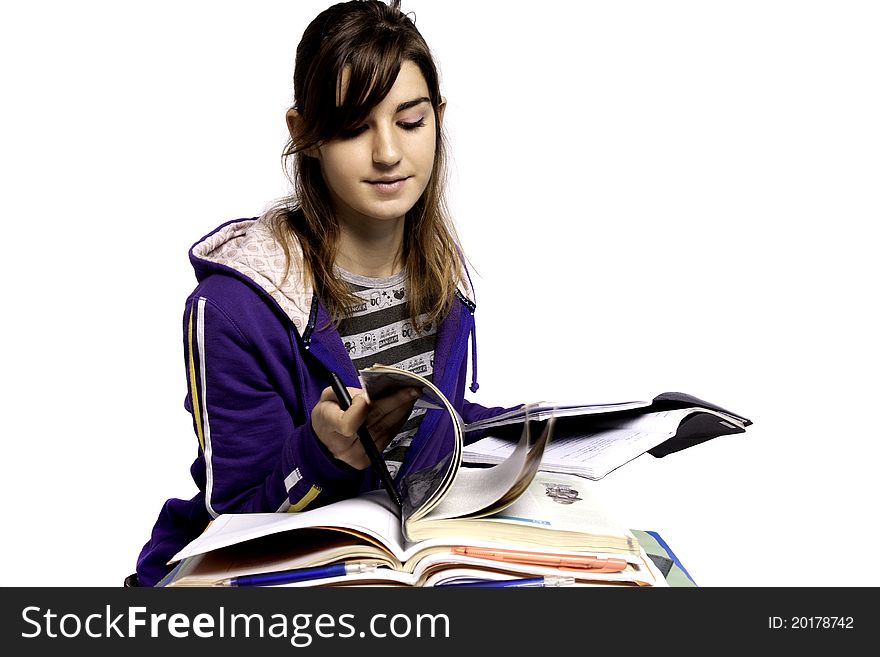 View of a teenager school girl studying on a white background. View of a teenager school girl studying on a white background.