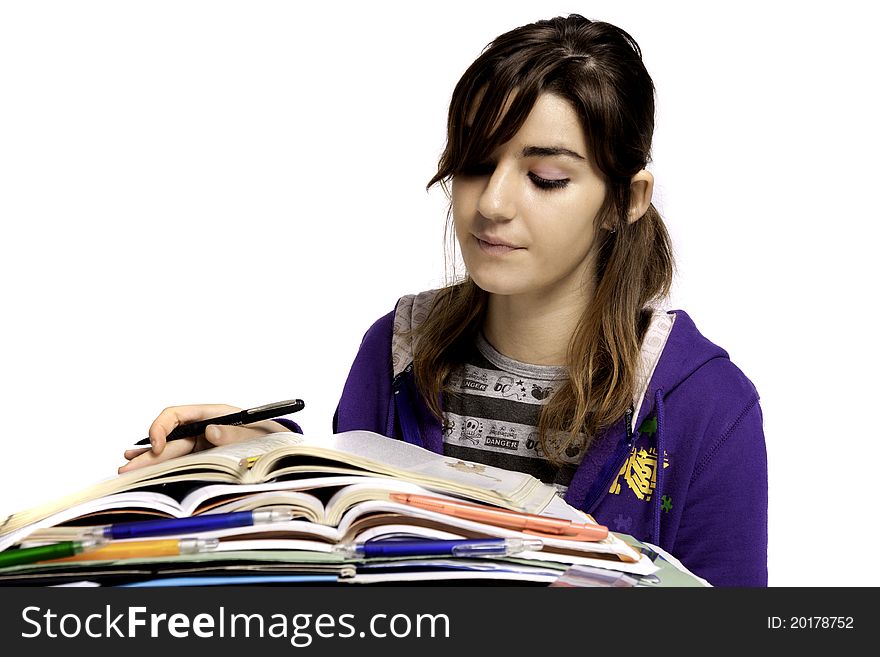 View of a teenager school girl studying on a white background. View of a teenager school girl studying on a white background.