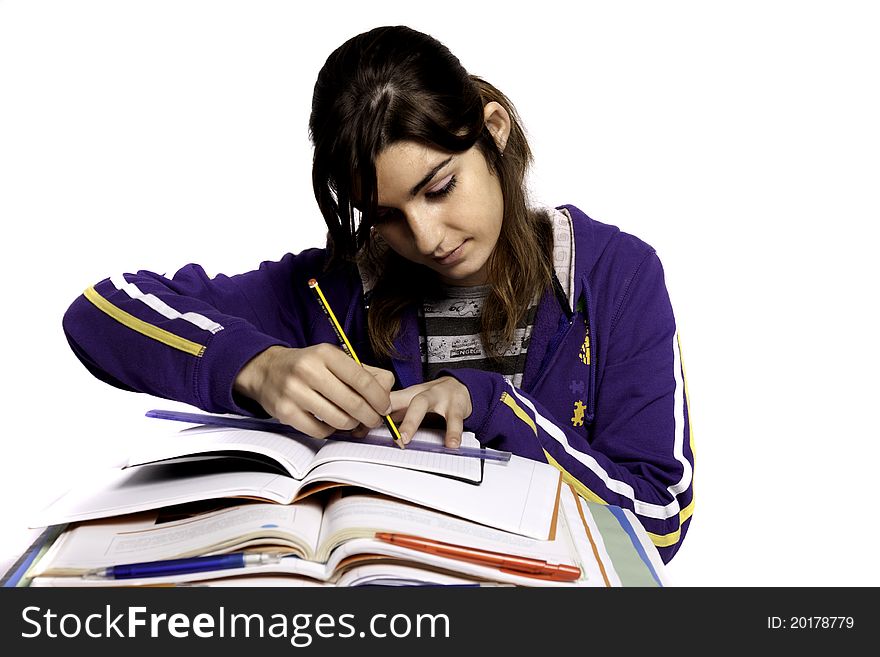 View of a teenager school girl studying on a white background. View of a teenager school girl studying on a white background.