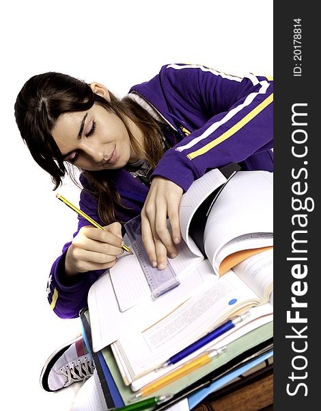 View of a teenager school girl studying on a white background. View of a teenager school girl studying on a white background.