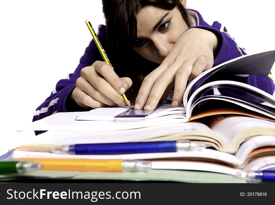 View of a teenager school girl studying on a white background. View of a teenager school girl studying on a white background.