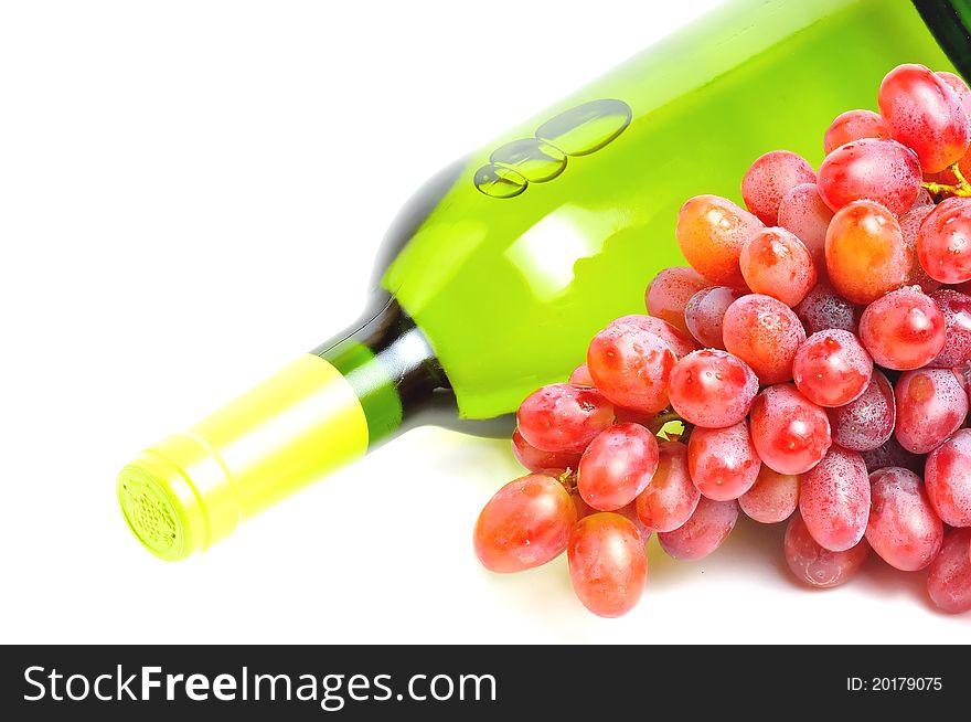 Bottle of white wine and bunch of pink grape isolated over white. Bottle of white wine and bunch of pink grape isolated over white