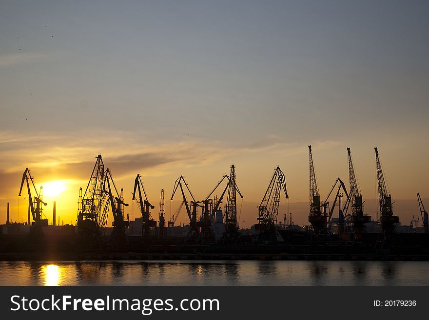 Industrial seaport on the summer sunset with cranes. Industrial seaport on the summer sunset with cranes
