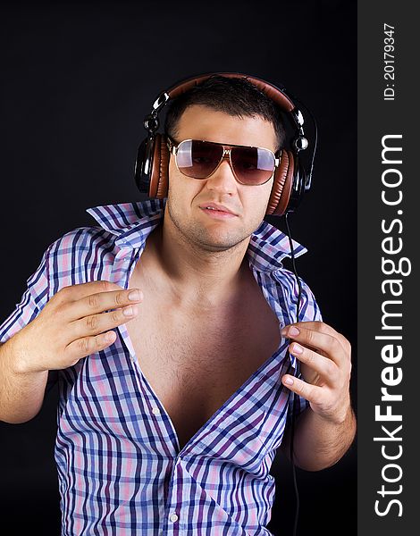 Stylish man is wearing headphones and posing. Stylish man is wearing headphones and posing