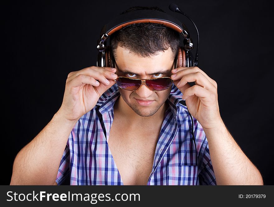 Man is listening music and staring. Man is listening music and staring