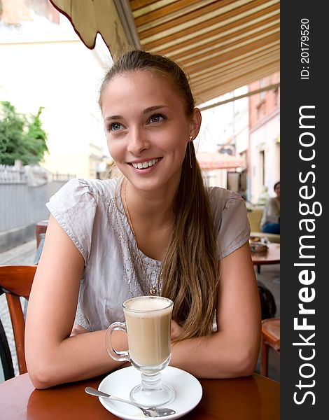 Woman With Coffee In Cafe