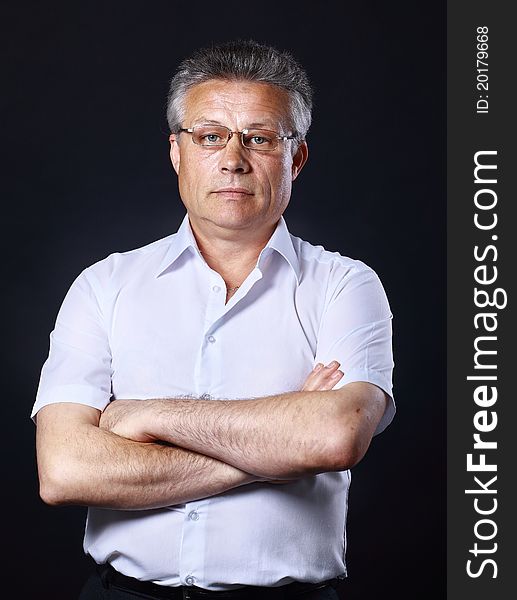 Portrait of successful business man standing on black background. Portrait of successful business man standing on black background