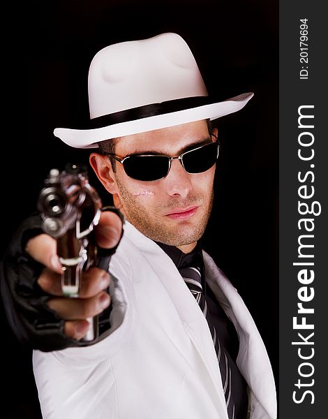 View of a white suit gangster man holding a gun. View of a white suit gangster man holding a gun.