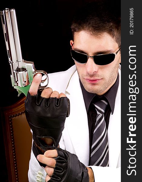 View of a white suit gangster man holding a gun.