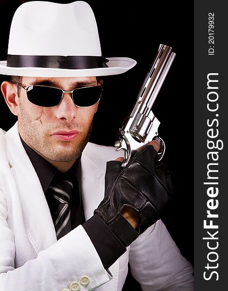 View of a white suit gangster man holding a gun.