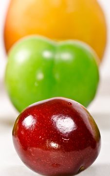 Three In A Row; Cherry, Plum And Apricot On A Whit Stock Image Three In A Row; Cherry, Plum And Apricot On A Whit Stock Image