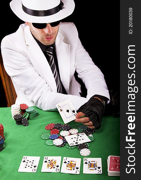 View of a gangster man playing some cards and poker. View of a gangster man playing some cards and poker.