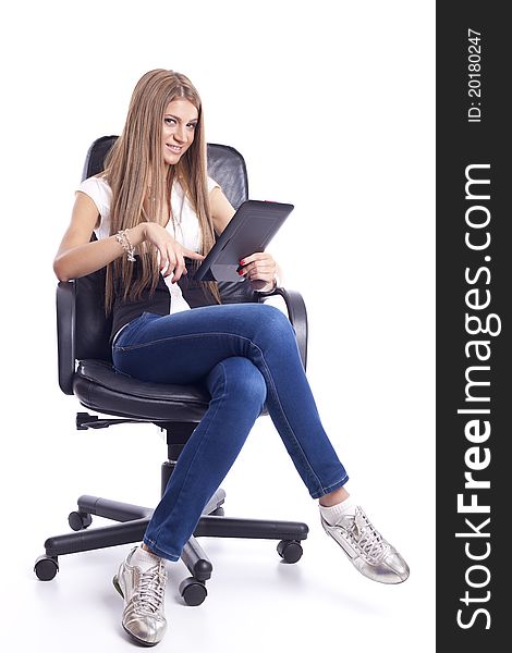 Beautiful Woman seating in Office chair and Using Tablet Computer. Beautiful Woman seating in Office chair and Using Tablet Computer