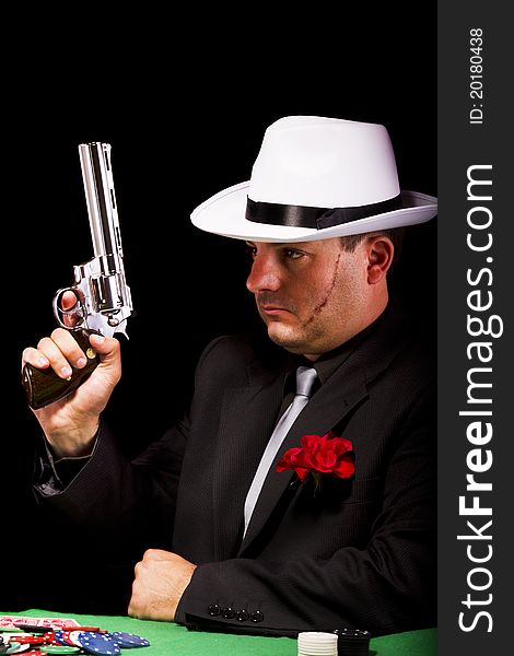 View of a dark suit gangster man holding a gun. View of a dark suit gangster man holding a gun.