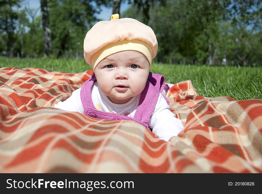 The portrait of the kid, lays on on a coverlet