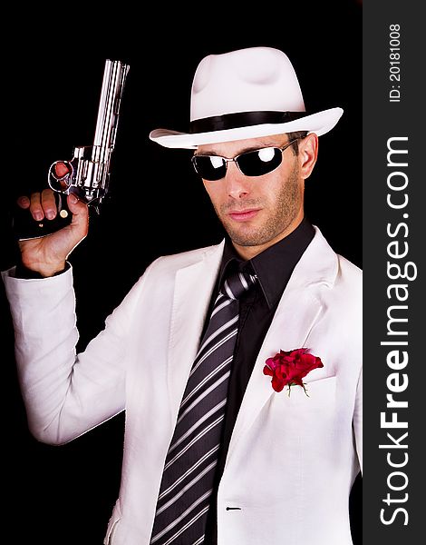 View of a white suit gangster man holding a gun.