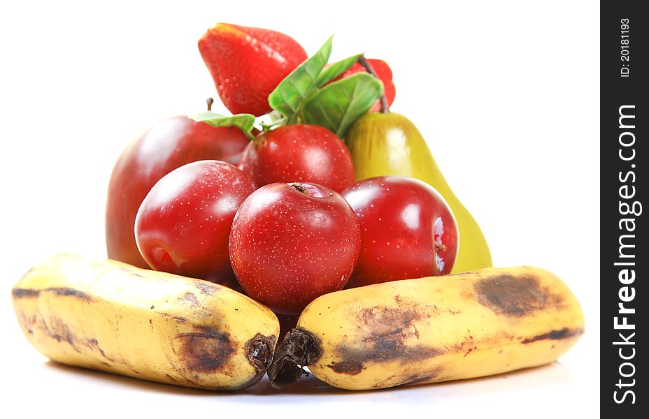 Ripe fruits lying over white background.