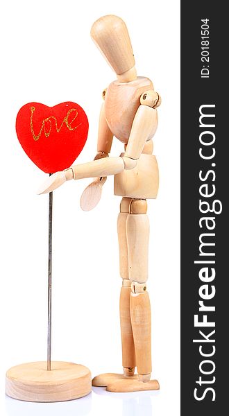 Wooden mannequin holding heart over white background. Wooden mannequin holding heart over white background.