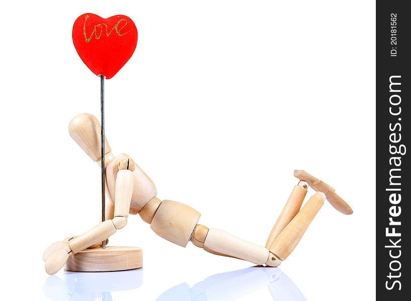 Wooden mannequin holding heart post over white background. Wooden mannequin holding heart post over white background.