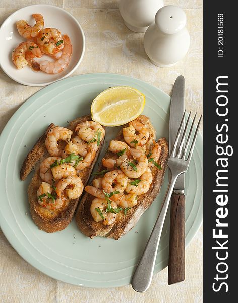 Toasted sourdough topped with king prawns and herbs. Toasted sourdough topped with king prawns and herbs