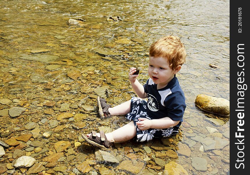 Young toddler playing in the water. Young toddler playing in the water.