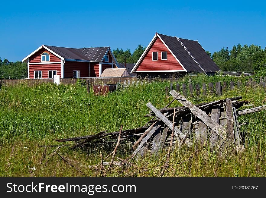 New houses and ruins at the background of grass and sky