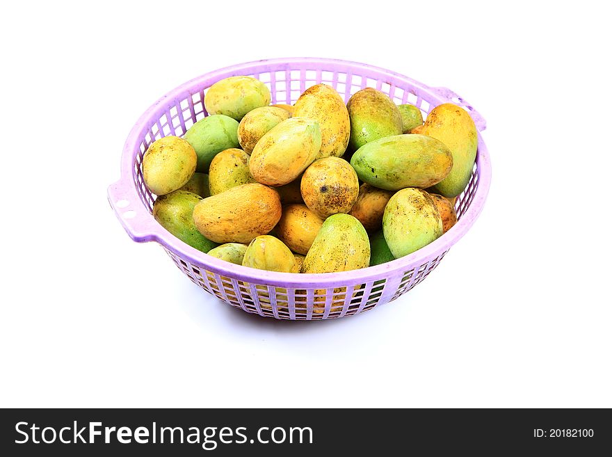 Ripe mangoes in basket over white background.