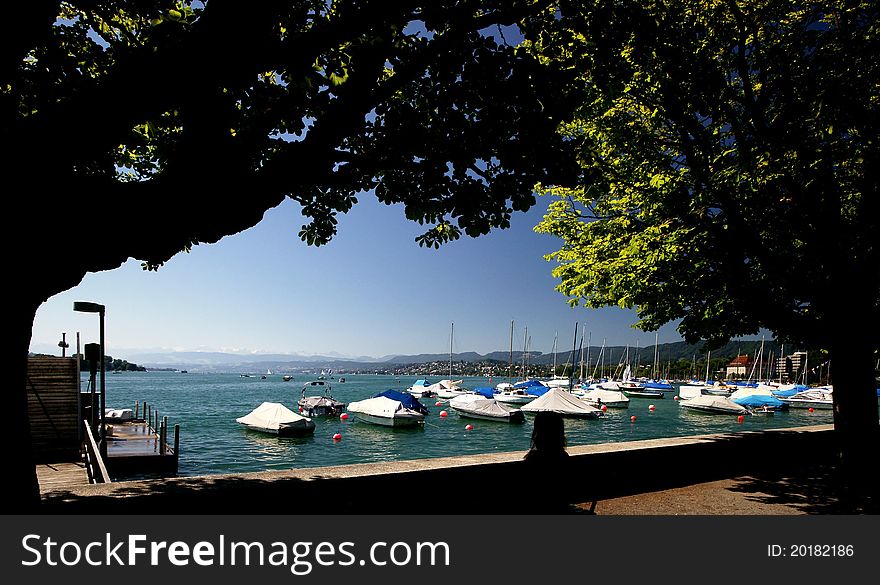 A view across Lake Zurich with the Alps in the back from Guisan Quai in Zurich Switzerland.