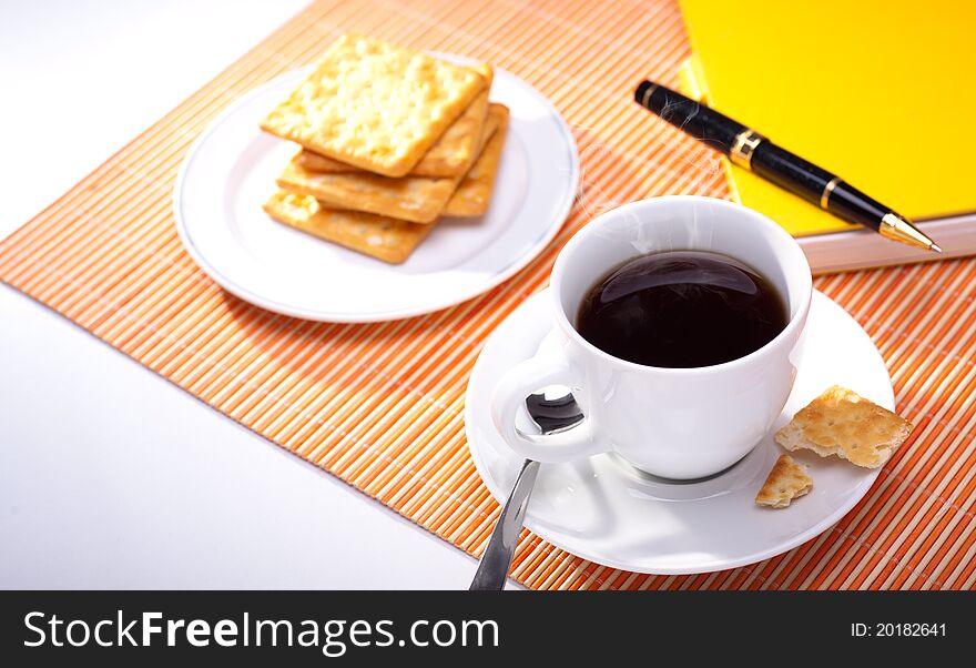 Hot coffee cup with bread on the work space