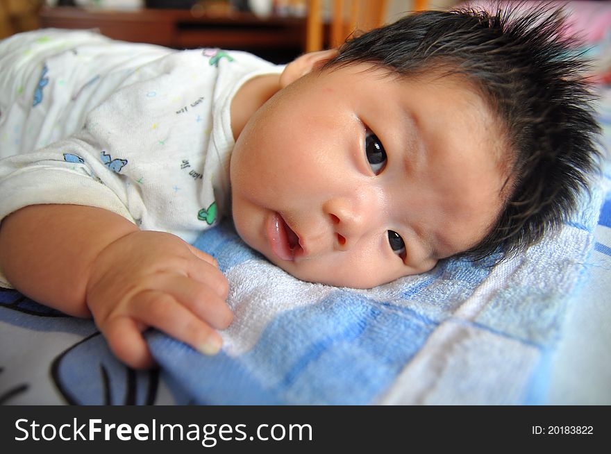 A 2 months chinese Baby girl lying on the bed. A 2 months chinese Baby girl lying on the bed