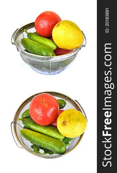 Tomatoes, cucumbers and a lemon in a strainer and rinsed in water. Tomatoes, cucumbers and a lemon in a strainer and rinsed in water