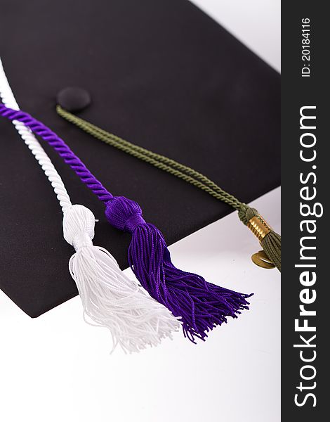 Graduation cap and tassles isolated on a white background